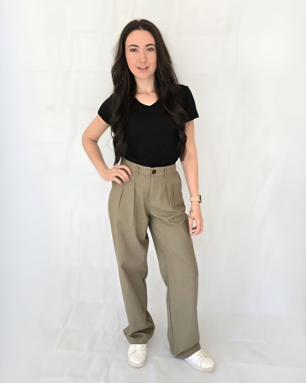Mum wearing comfy sage linen tailored pants and a black V neck tee cotton