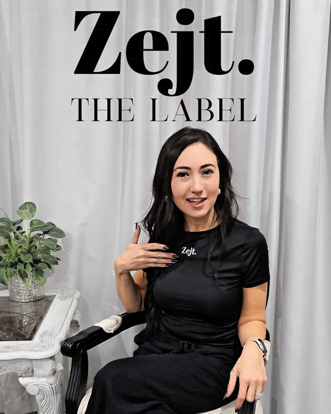 Woman in a black outfit sitting on a chair with 'Zejt. THE LABEL' branding.