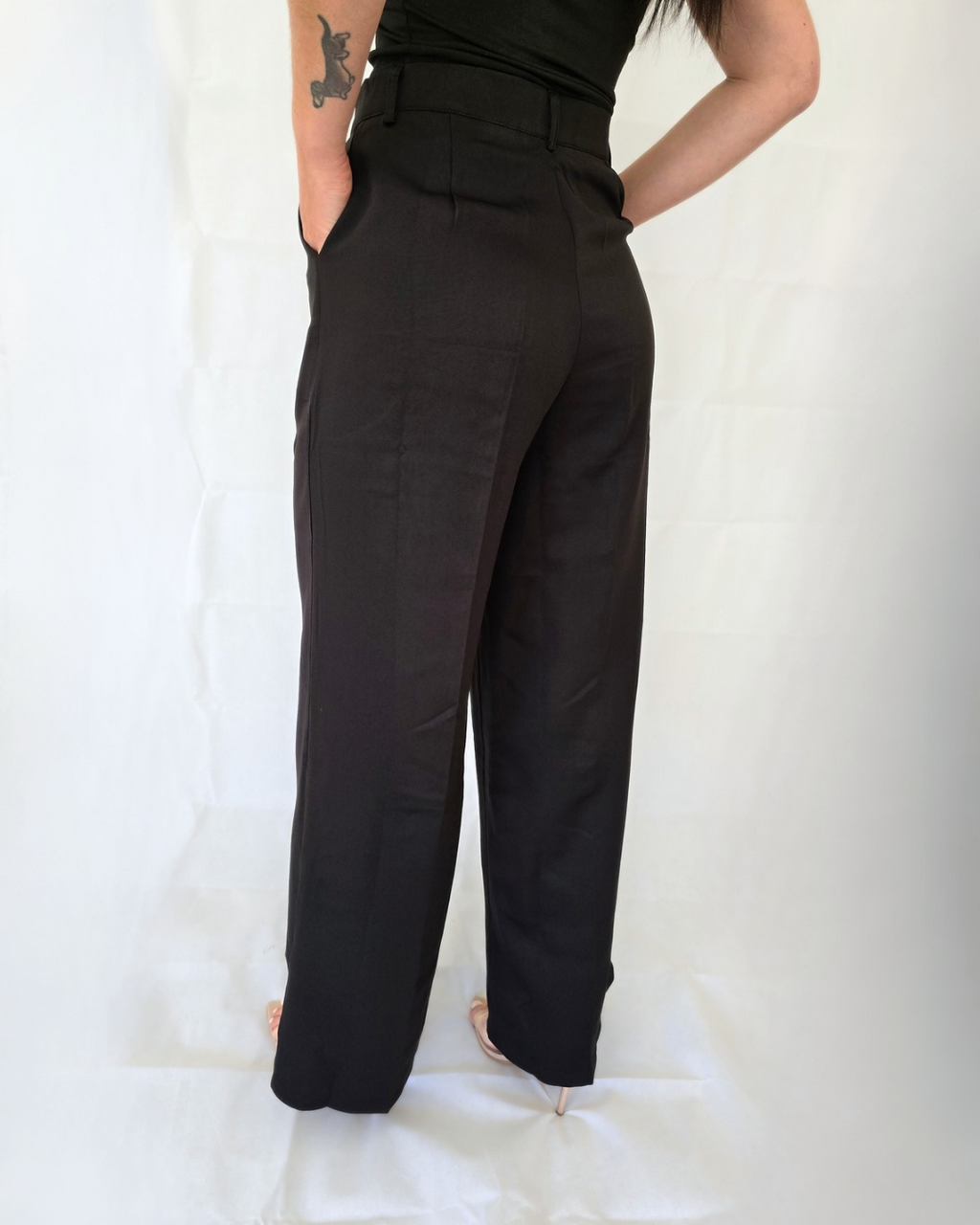 Woman wearing black high-waisted pants for work in business