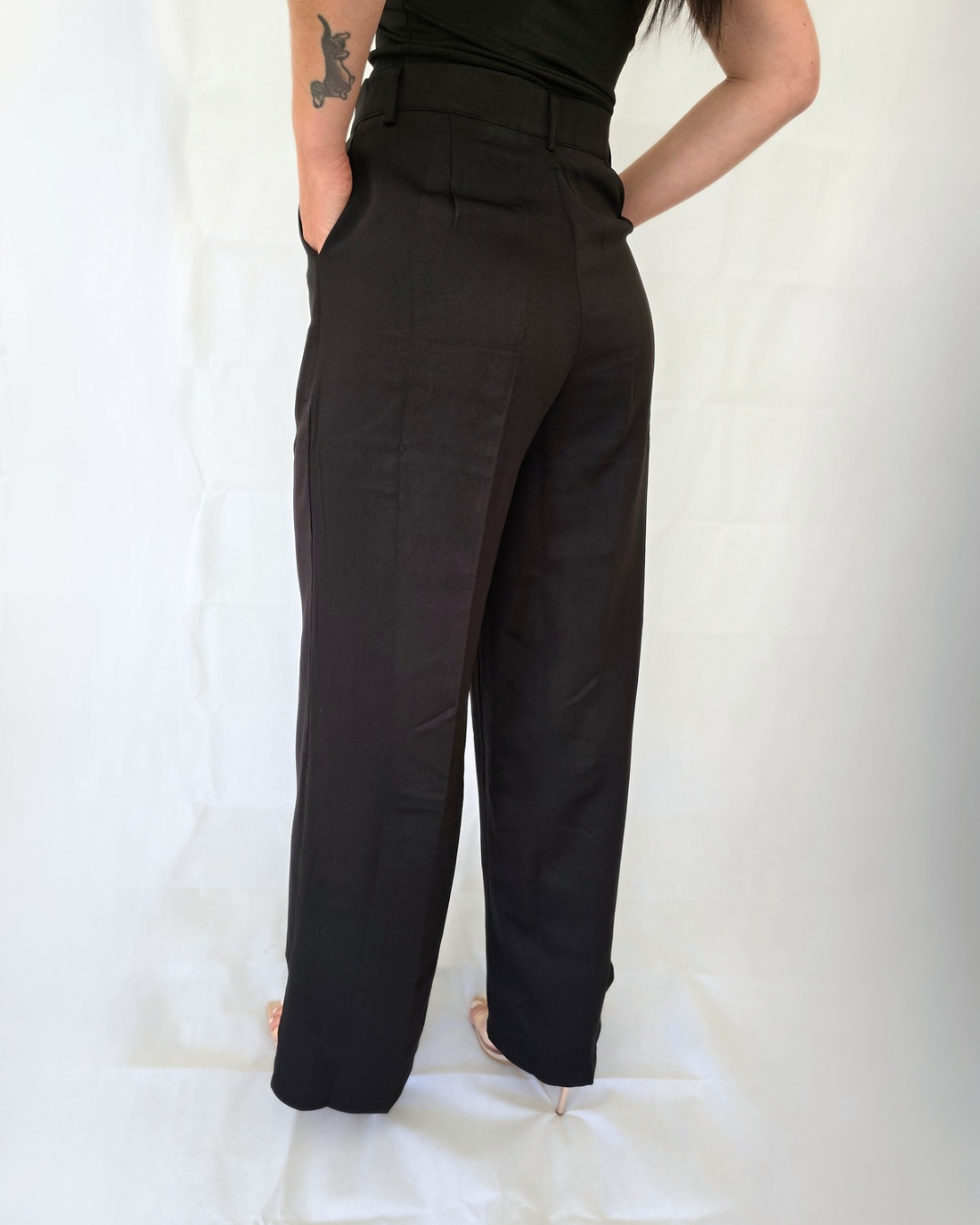 Woman wearing black high-waisted pants for work in business