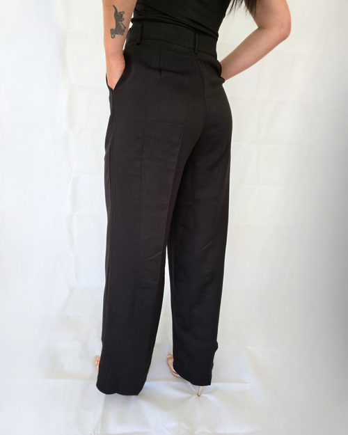 Woman wearing black high-waisted pants for work in business
