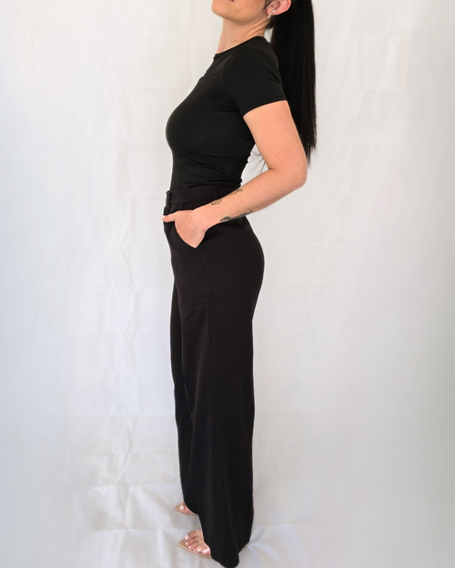 Woman wearing Black tailored business pants with a flowy wide leg