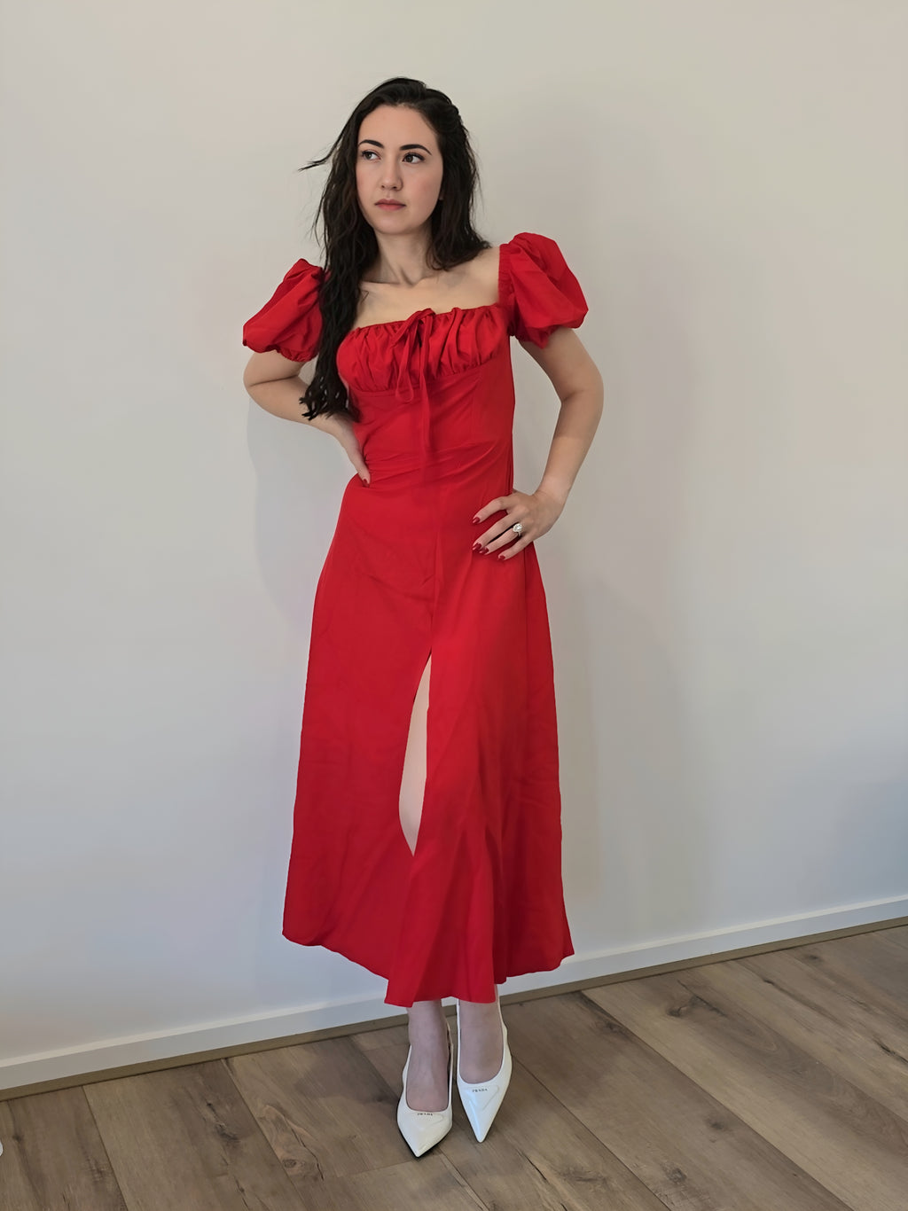 Womans elegant red dress with puff sleeves and split