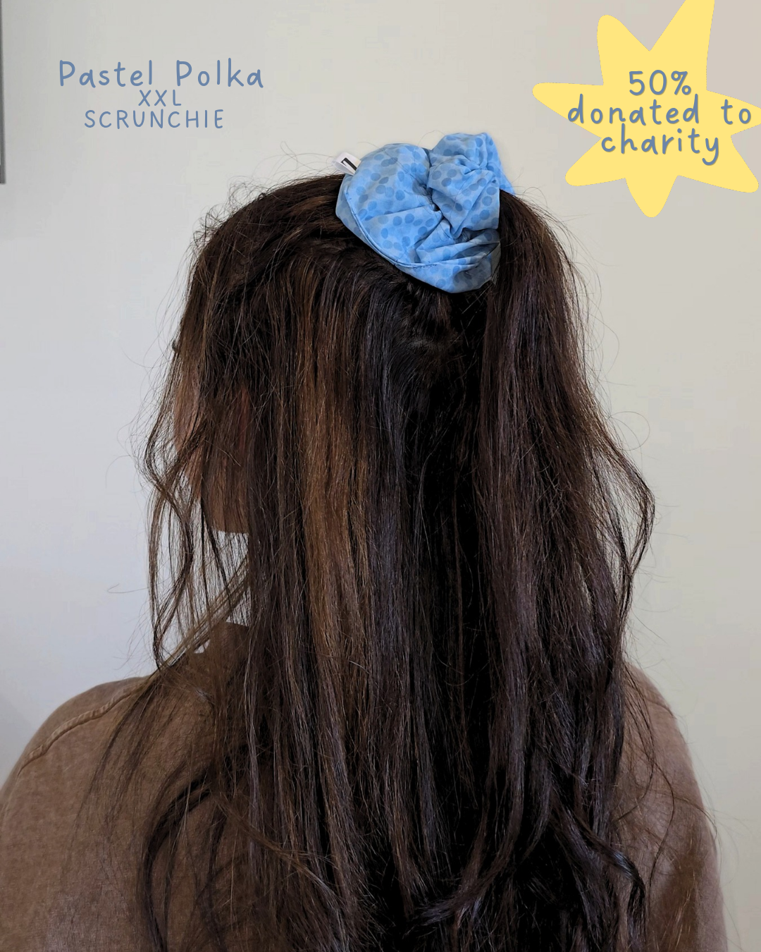 Person with a blue scrunchie in their hair, with text indicating 'Pastel Polka XXL Scrunchie' and '50% donated to charity'.