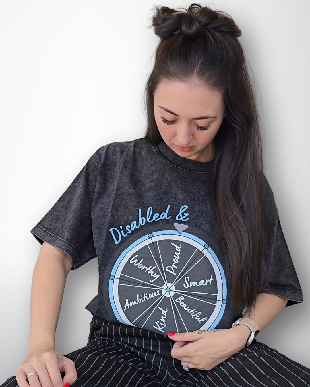 Person wearing a black t-shirt with a graphic design on a white background