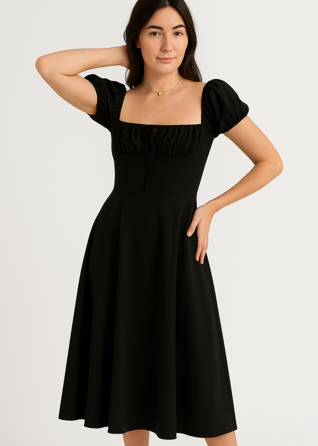 Woman wearing a black summer dress with puff sleeves on a white background