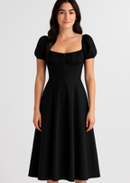 Woman wearing a black dress with puff sleeves on a white background