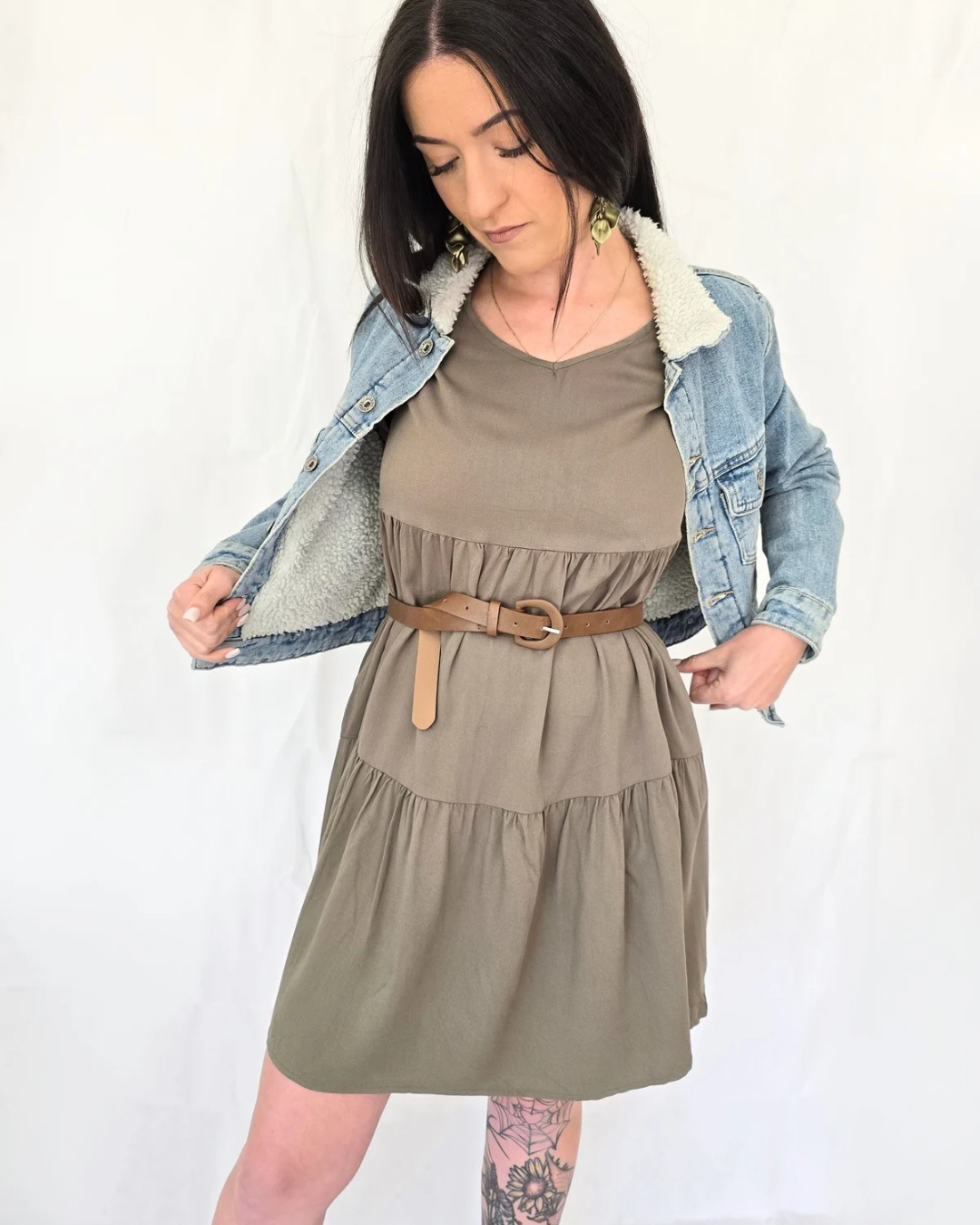 Woman wearing a green dress with a denim jacket summer plus size pockets