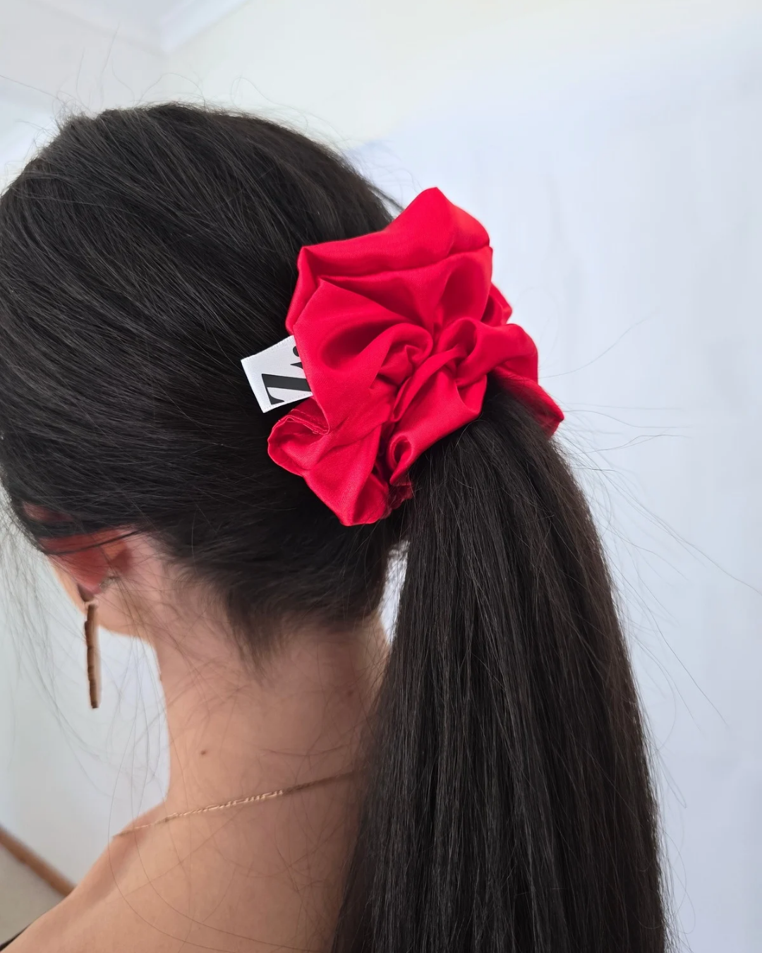Red hair scrunchie on a ponytail hair growth