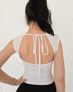 White sleeveless top with open back and ribbon details womens trending viral clothing