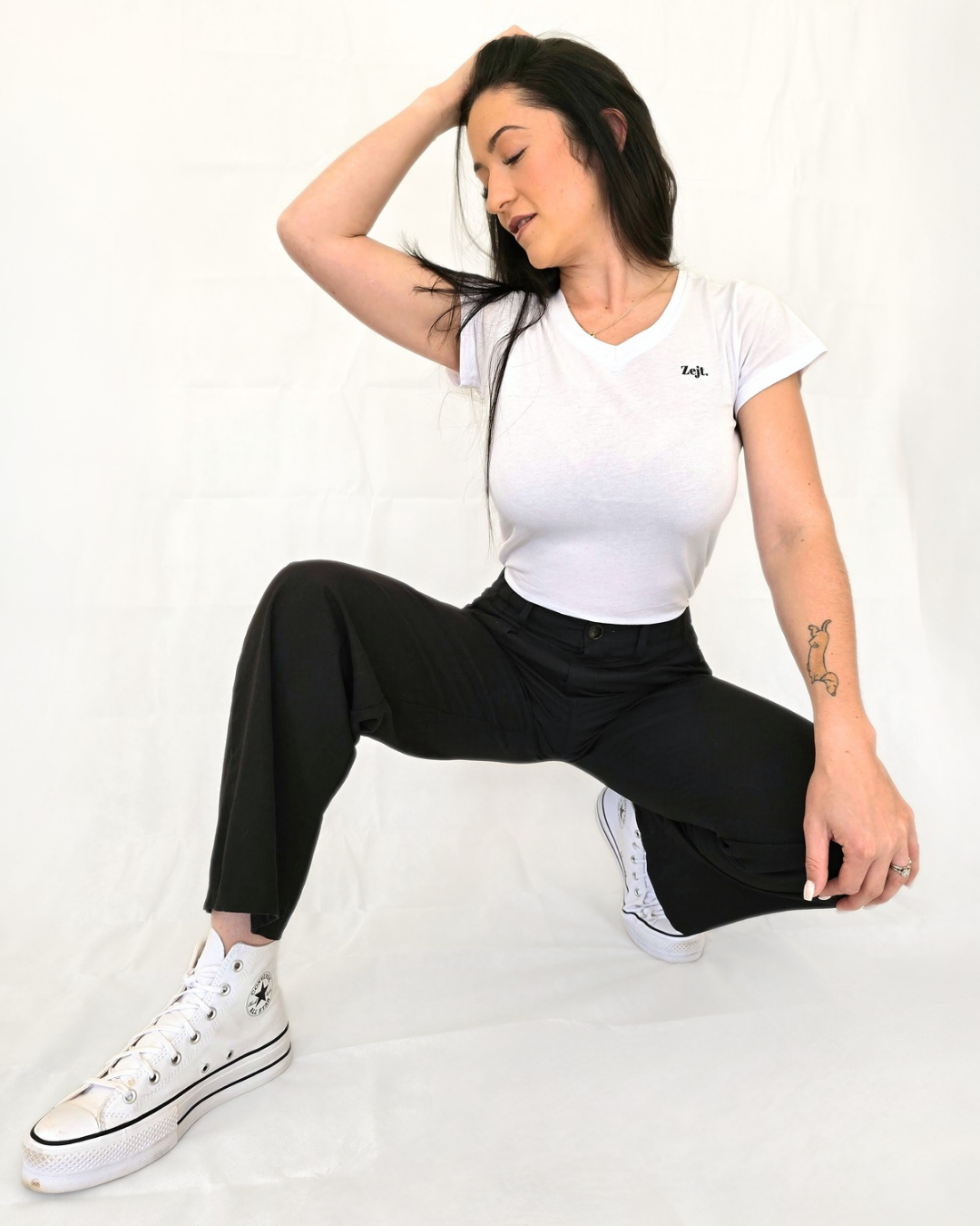 Woman in a white v-neck  t-shirt and black pants versatile elastic